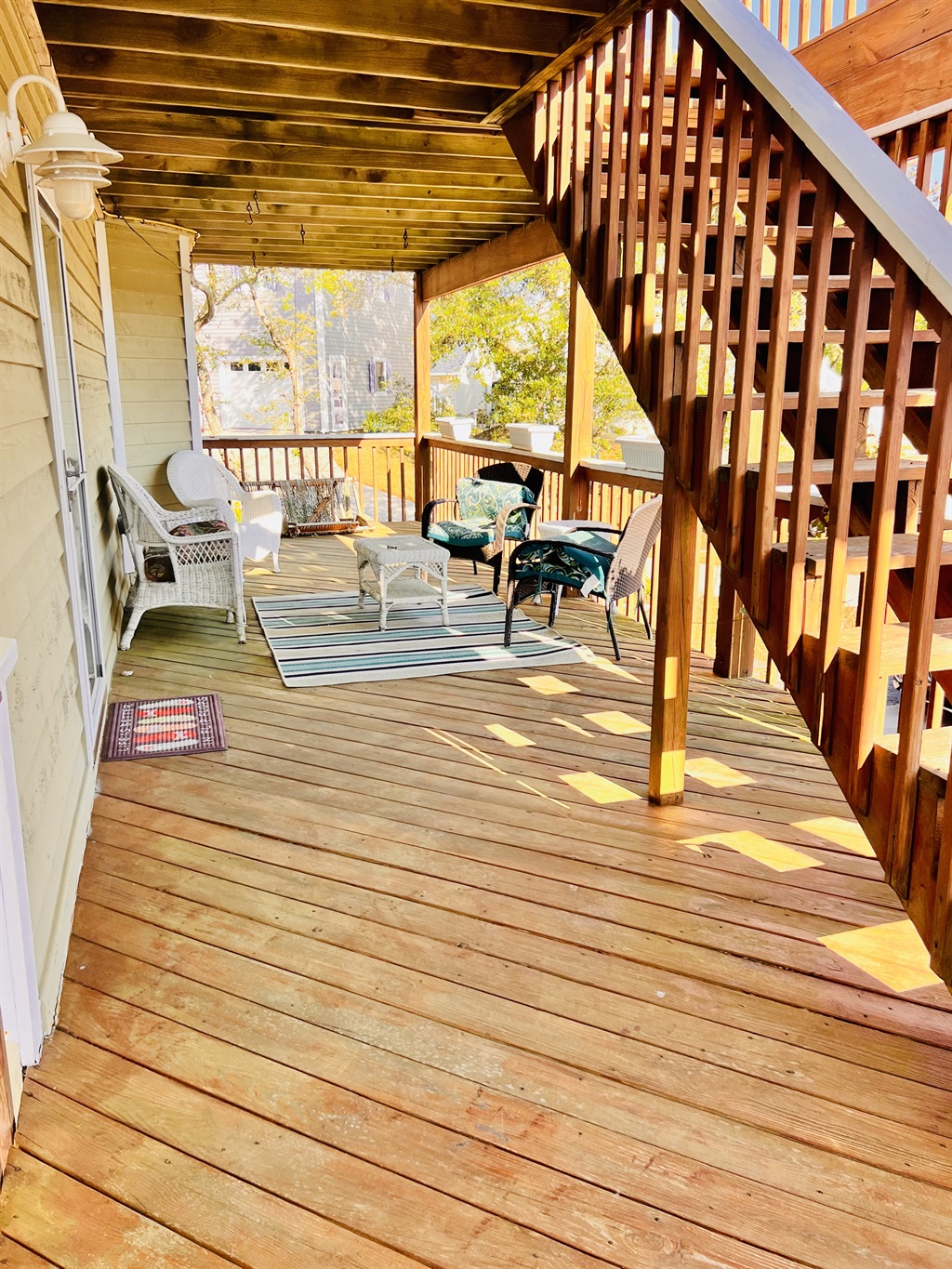 2nd floor deck front of house with seating
