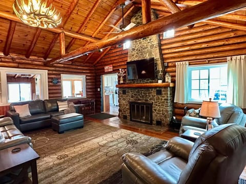 Welcome to the inviting living room, with plenty of comfortable furniture and centered around a warm fireplace - a space designed for making cherished memories with friends and family.