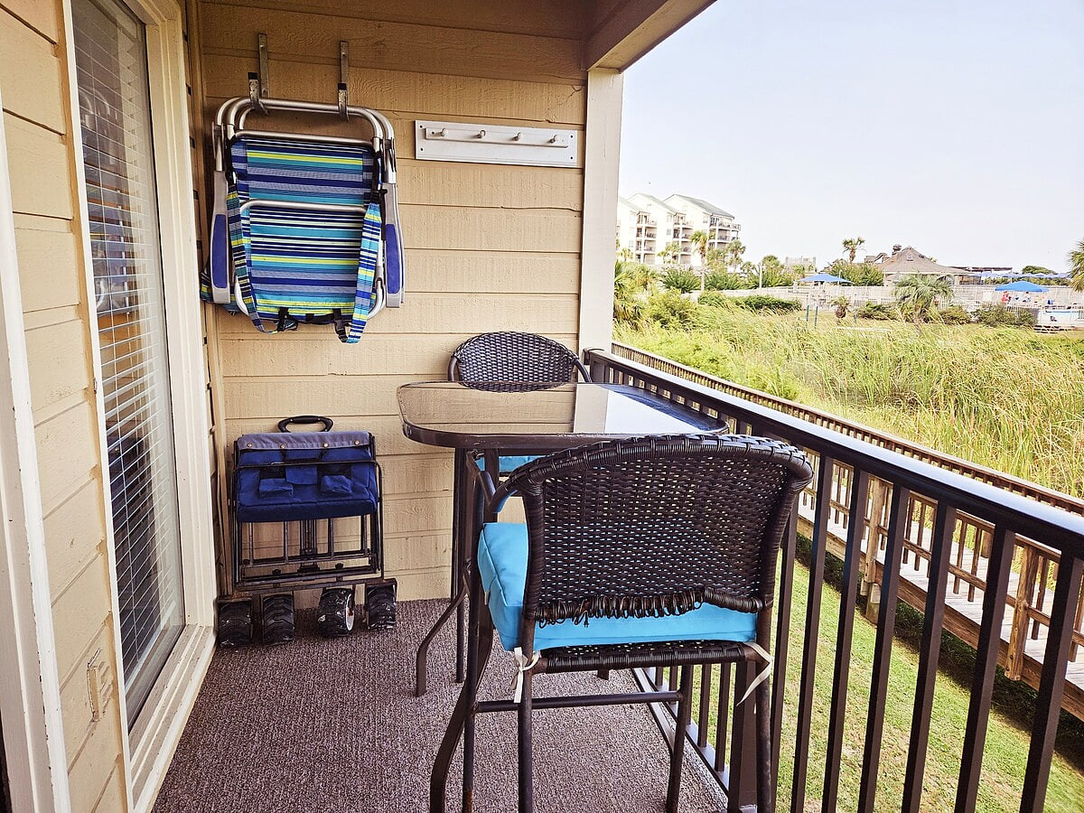 Enjoy the balcony view from the comfortable rockers or high top chairs.  Beach chairs and beach cart are on balcony for you to enjoy while cooler and kid toys can be found inside!