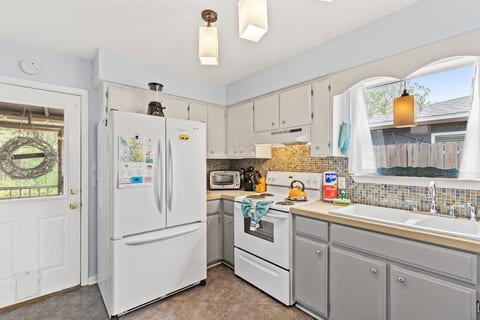 The full kitchen has a 2 kinds of coffee makers, a toaster oven, stove, microwave, large fridge, and a dishwasher.