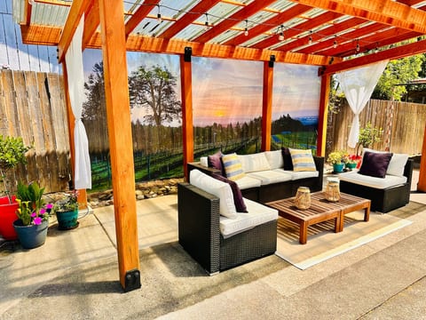 Custom Designed Trellis - Real wood (not a kit) • Couch • Landscape lighting year-round •  Lights go on at dusk • BBQ • Dining Area (always available) • Fire-pit • Outdoor Shower 