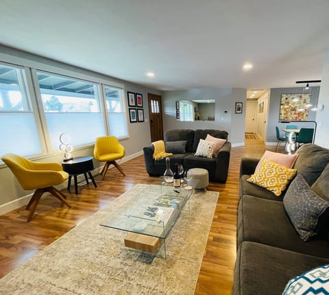Comfortable Living Area • 55" Smart TV • Bose sound bar • Electric Fireplace. Seating for 7 in living room • Full of natural light • Fun and comfortable swivel chairs • Oversized couch