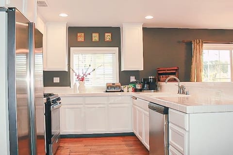 Full kitchen with a Keurig duo, new oven range, new dishwasher, pots/pans, casserole dishes, silicone utensils, dishes, knives, silverware, wine glasses, drink ware, and kid-friendly plastic dishes, cups, and more.