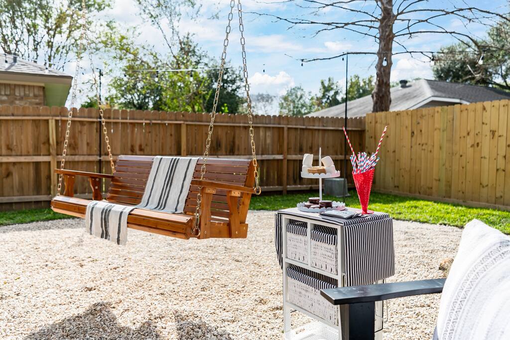 Relax and unwind on the spacious outdoor swing, perfect for enjoying the breeze