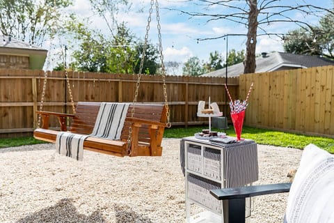 Relax and unwind on the spacious outdoor swing, perfect for enjoying the breeze