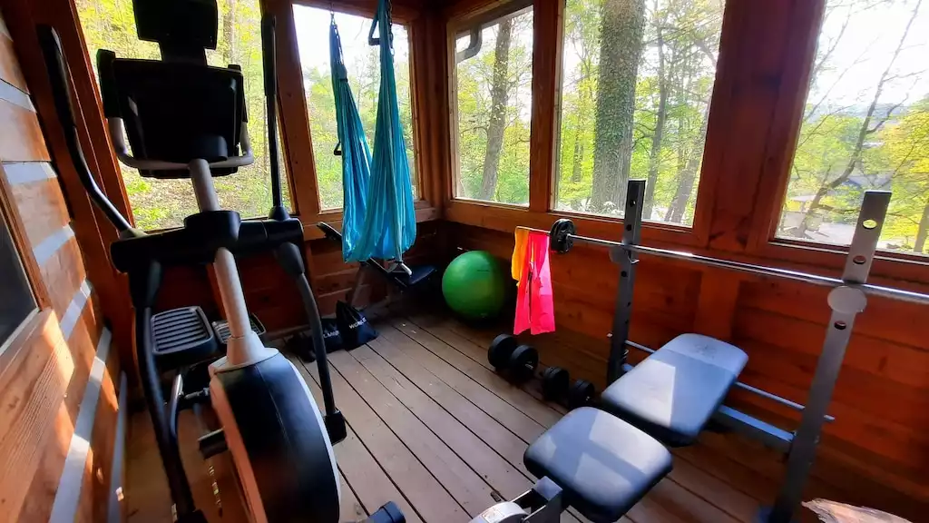 Front porch mini gym with elliptical, yoga swing, weight bench and a few extras - The Mountain Forager Cabin - Swain County