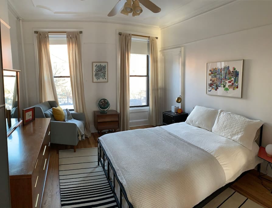 Master bedroom with queen bed and street view