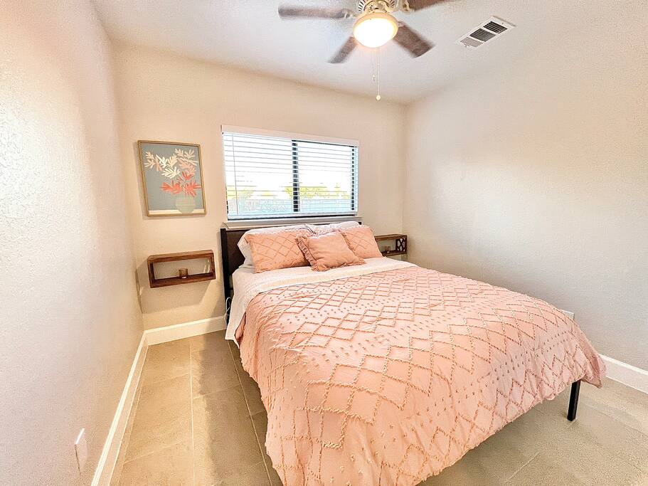 Breathe easy in this well-ventilated bedroom, complete with a ceiling fan and a window that lets in plenty of sunlight - 4BR Family Oasis | Prime Location, Fast Wi-Fi-TCF - Converse