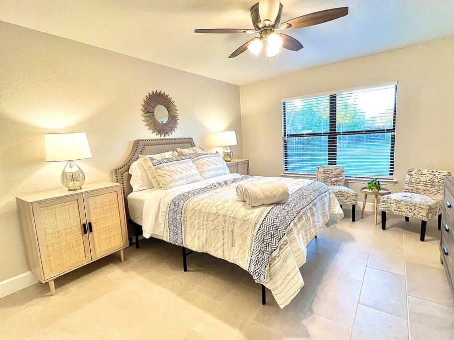 A peaceful primary bedroom with a comfortable sitting area, designed for your relaxation and entertainment - 4BR Family Oasis | Prime Location, Fast Wi-Fi-TCF - Converse