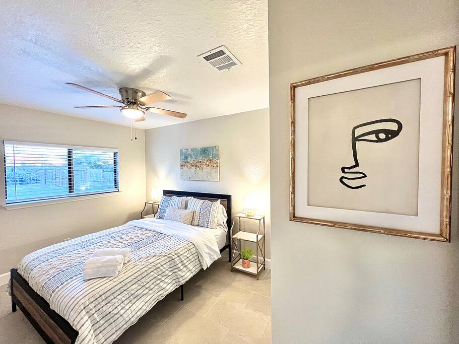 The perfect blend of comfort and freshness, this bedroom features a ceiling fan and a window offering a light, airy feel - 4BR Family Oasis | Prime Location, Fast Wi-Fi-TCF - Converse
