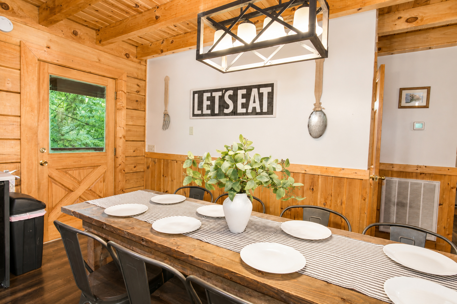 “Let’s Eat!” Gather around the spacious dining table for shared meals, laughter, and memories made together.