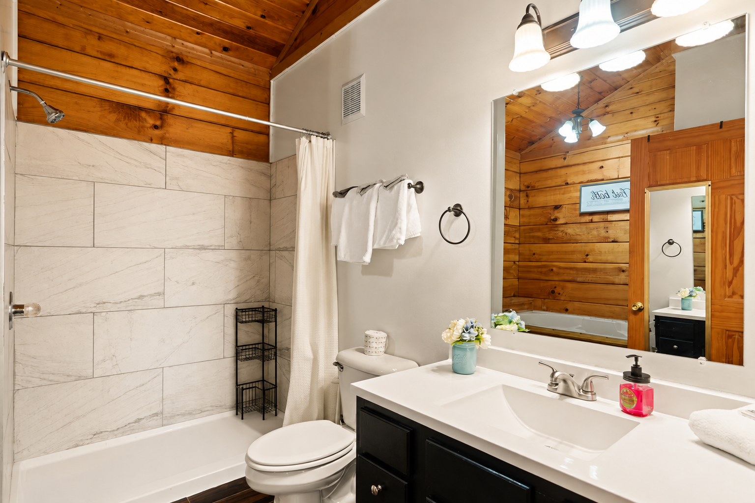 Refresh and recharge in the private en suite, featuring a spacious vanity and tiled shower.