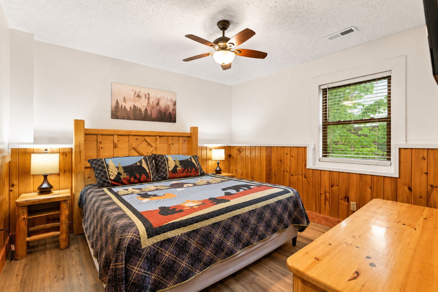 Relax in a comfortable lower-level king bedroom with a peaceful partial mountain view.