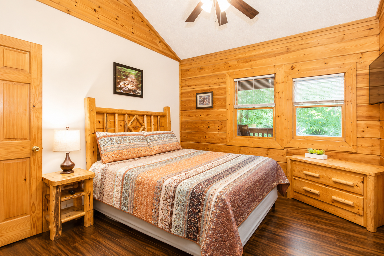 Rest easy in another inviting main-level bedroom, with a king bed, vaulted ceiling, and peaceful wooded views.