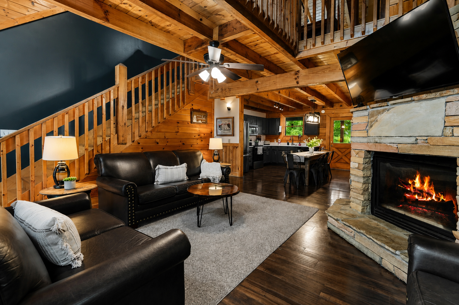 The stone fireplace in the warm, open great room is perfect for relaxing together after a day in the Smokies.