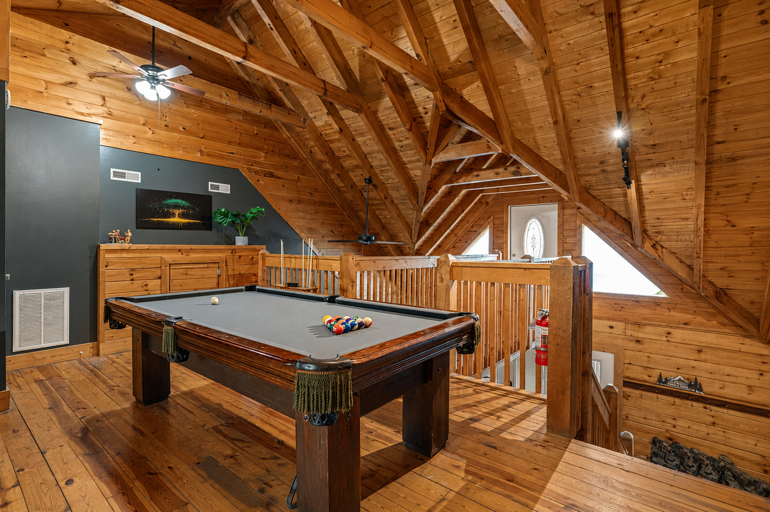 Challenge your crew to a game of pool in the spacious loft, surrounded by the warmth and character of the cabin’s soaring wood ceilings.