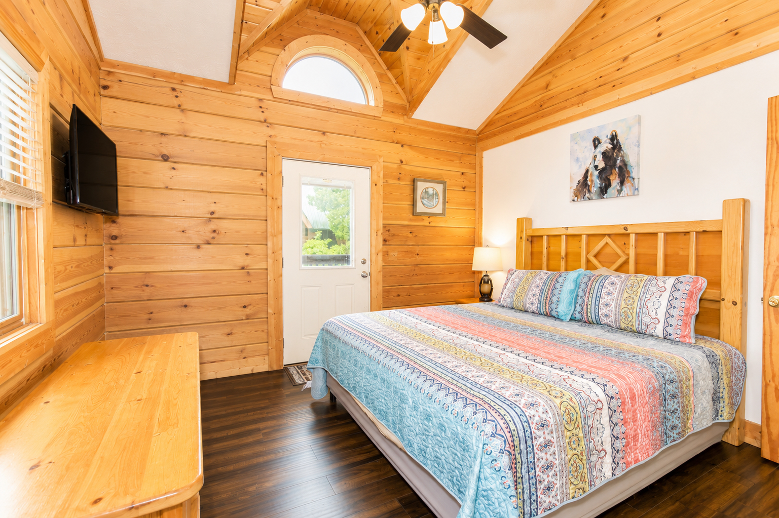 Settle into this inviting main-level bedroom, with a king bed, vaulted ceilings, and private deck access.