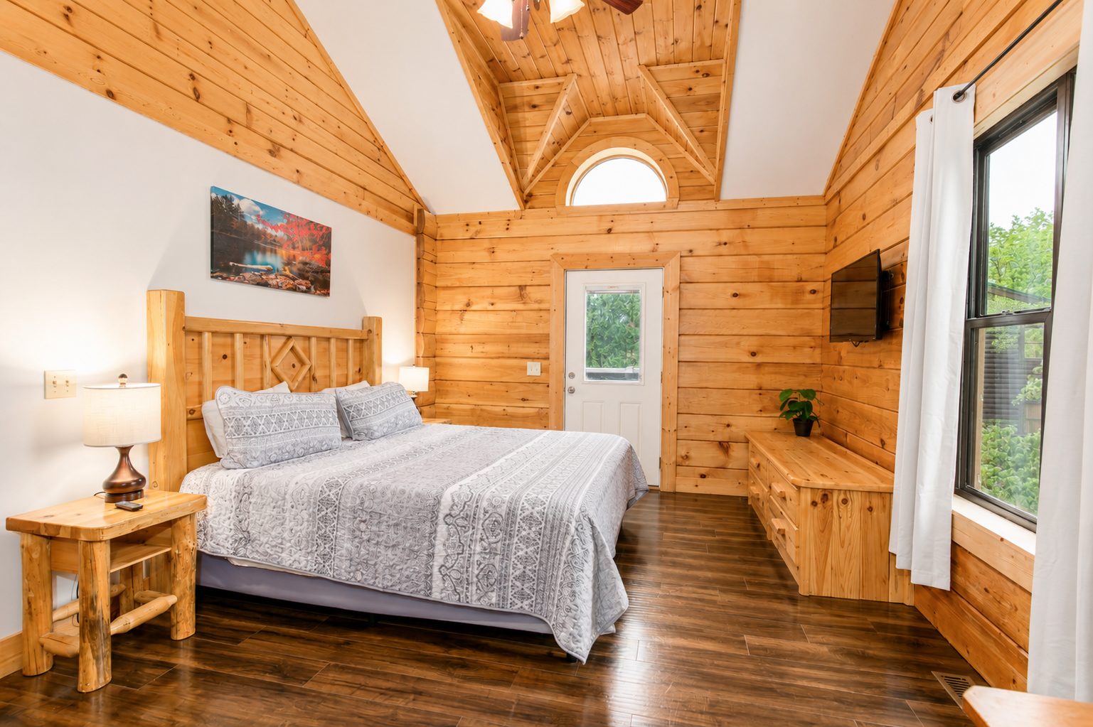 Retreat to the spacious primary suite, with soaring ceilings, warm wood details, and your own private deck access.
