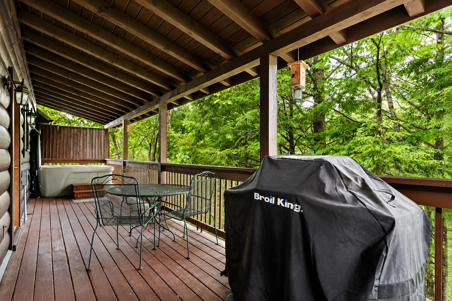 Grill, dine, and soak in the hot tub on the covered deck surrounded by peaceful Smoky Mountain woods.