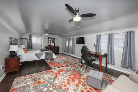 Bedroom 1 - Queen bed, TV, dresser, lamps, work station desk, chair, foot stool, alarm clock, USB charger, luggage rack, fans, extra closet space