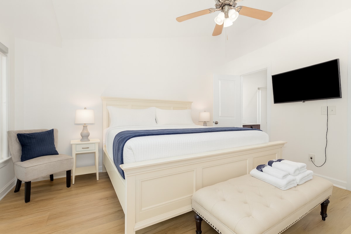 Primary bedroom with 42” smart TV and private full bath, dual vanity