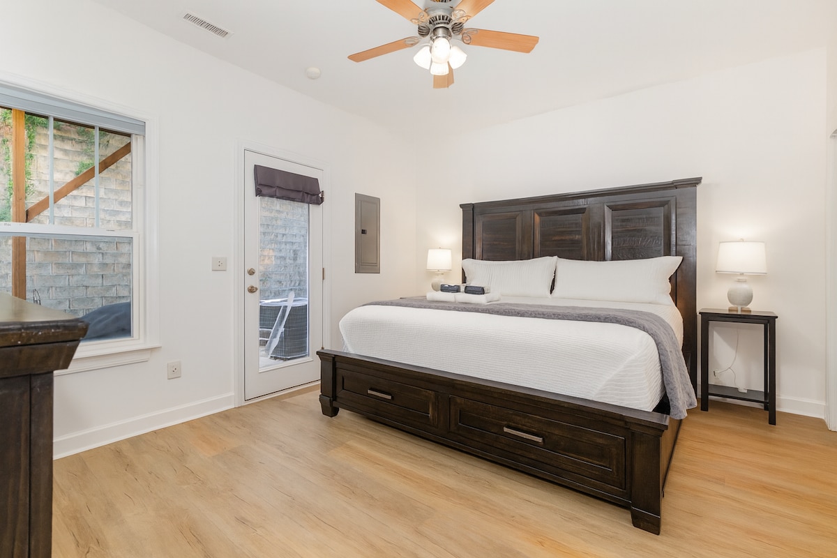 King bedroom with private half bath attached - ground floor, back patio access. No door on this bedroom but there is a room divider for privacy provided.