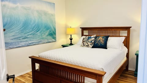 Ocean wall art and nightstands with charging stations can be found in the second bedroom