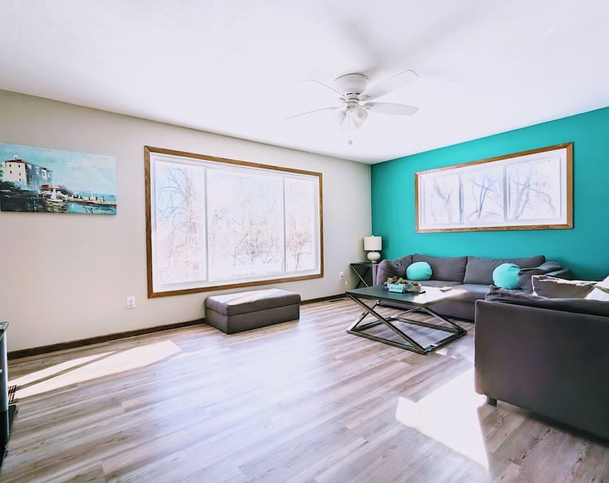 One of the two living rooms with panoramic views of the private backyard and the creek