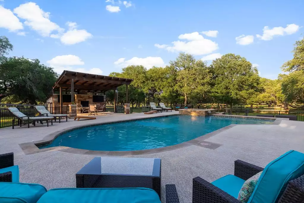 Picture yourself poolside with views of the Hill Country. - Main House at Whispering Oaks Estate - Dripping Springs