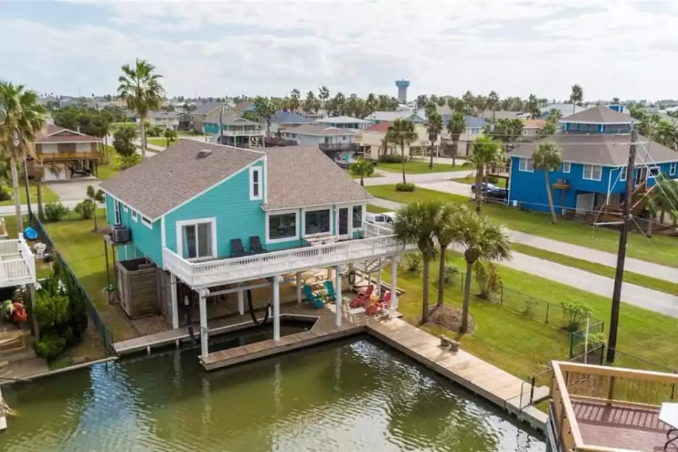 Bahama Breeze and her canal, bulkhead and boat slip. This is the rear of the home and you can see the fence goes around the entire property - perfect for keeping your pet secure! The deck overlooks the canal and bay.