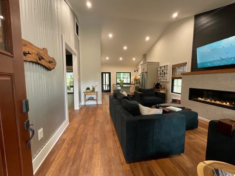 living room at entrance with gas fireplace and smart tv
