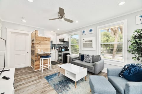 This is the living room and kitchen, as seen from the front of the unit. The entry door is to the left and the bedroom door is next to the pallet wall.