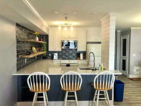 New cabinets, countertops, backsplash, floors, microwave, and sink - this kitchen is ready for some meals to be made and some cocktails to be crafted!