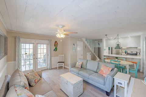 A bright, open living room and kitchen flow seamlessly into one large shared space, so everyone can stay connected—whether cooking, dining, or unwinding.