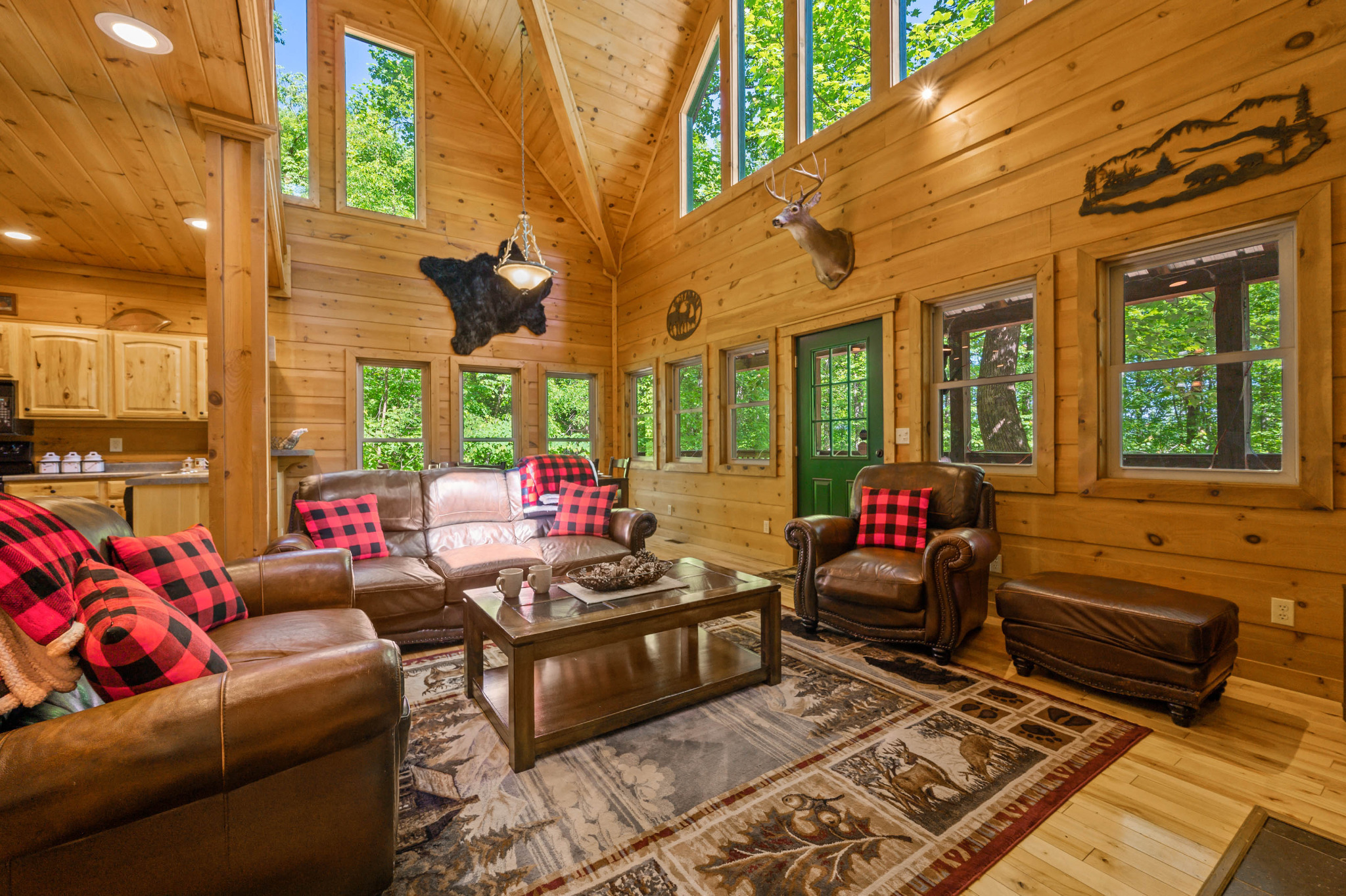 Spacious open living area that connects with the dining area & kitchen.  Tall ceilings with cathedral windows allow tons of natural light, and views of the woods.  Comfortable furniture, seats 6.  