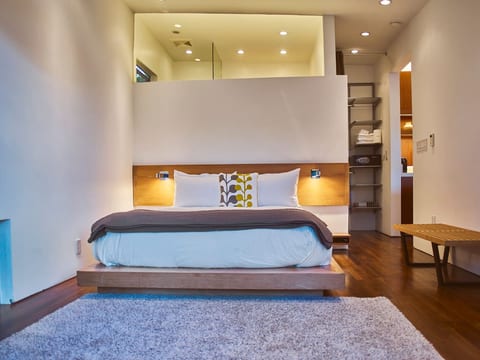 Bed room with clerestory bathroom window.