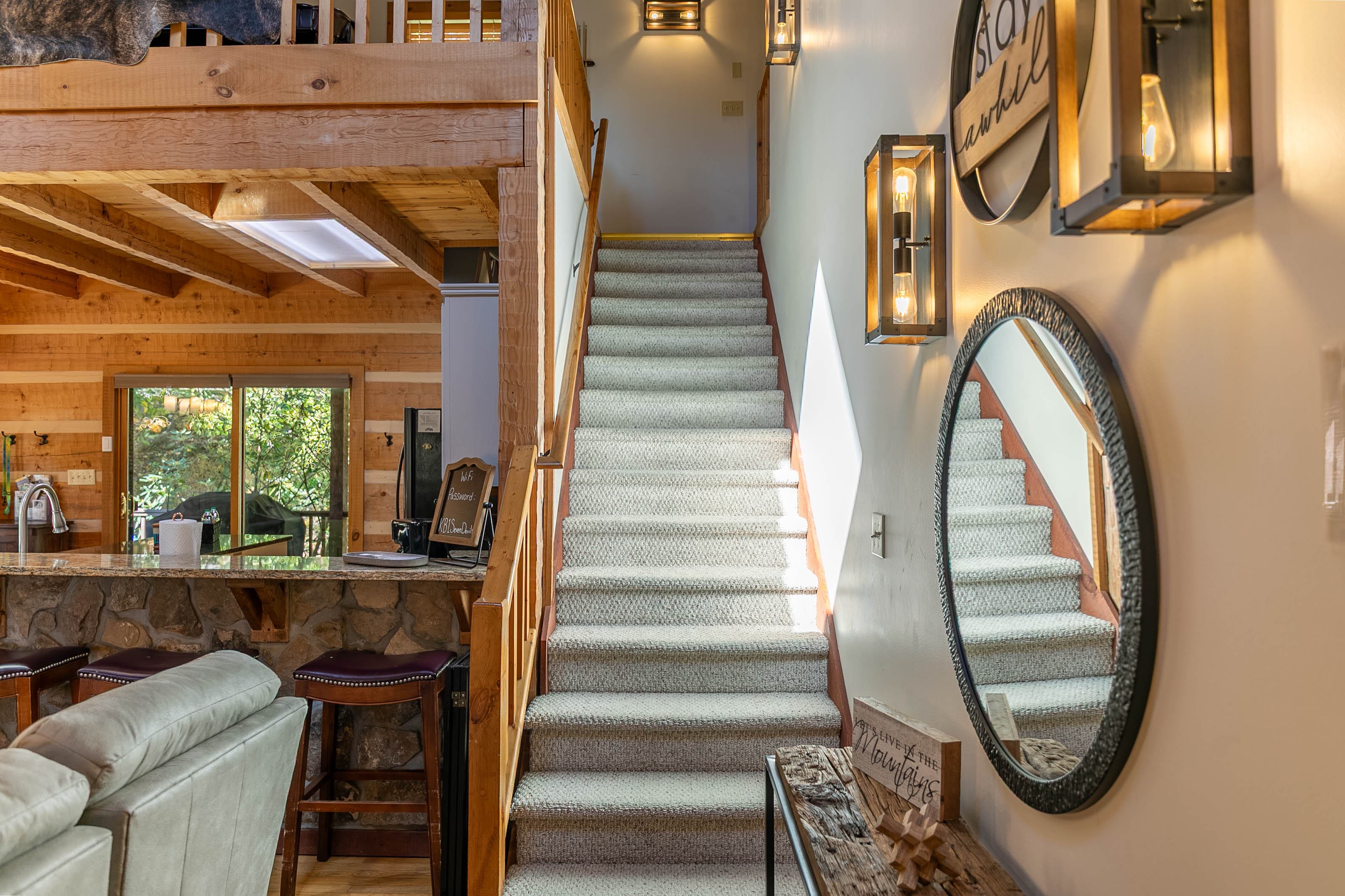 Staircase to the loft area- pool table, workspace, king bedroom, and full bathroom