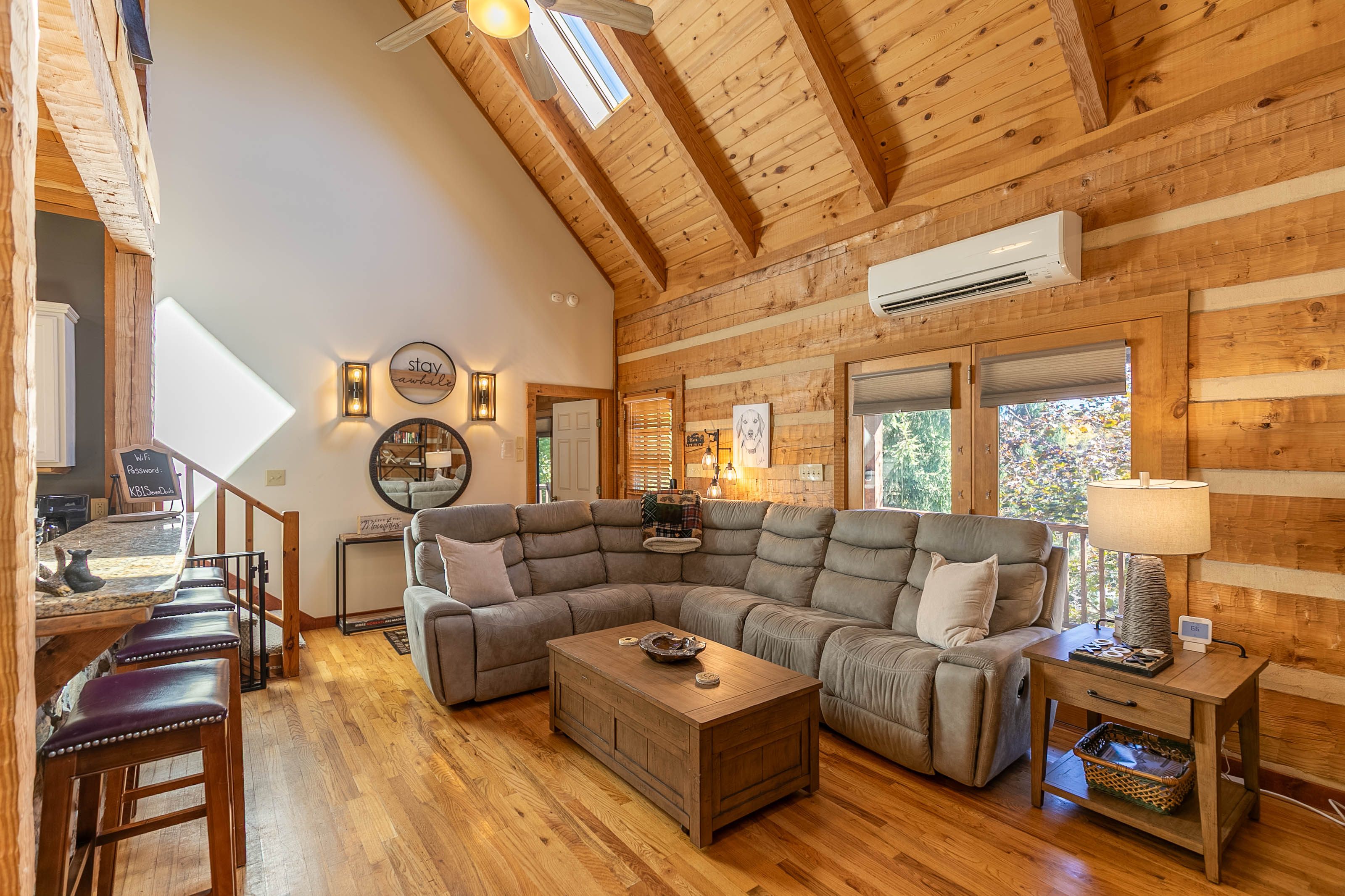 Main level common area-Sectional has three recliners, family games are located in the coffee table, and four bar stools at the bar.