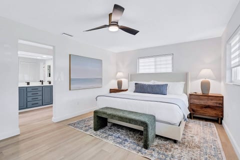 Primary Suite features a 65" TV, walk-in closet, memory foam king mattress, and large en-suite bathroom.