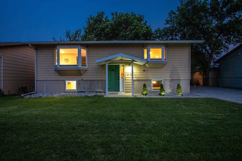 Welcoming split-level home with glowing windows and great curb appeal