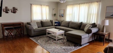 Livingroom with large sectional sofa sleeper. The pull out mattress is queen size.