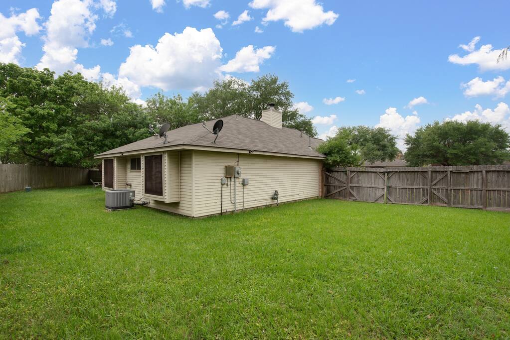 A stunning large green backyard awaits, offering plenty of space for family activities, gardening, or simply enjoying the serene surroundings