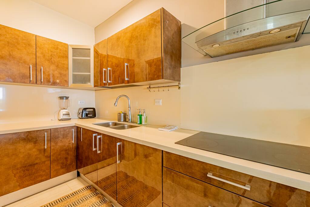 To the left is the laundry room with washer and dryer and a sink to rinse the sand of your bathing suits!