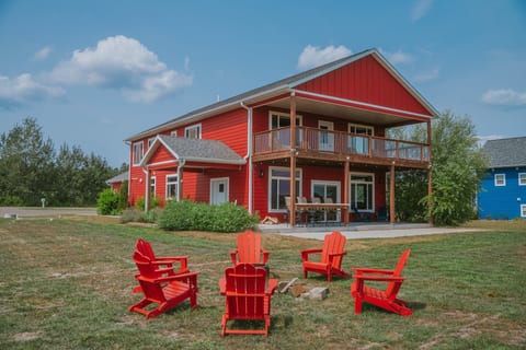 Bright red retreat with big deck, patio, and Adirondack fire pit seating