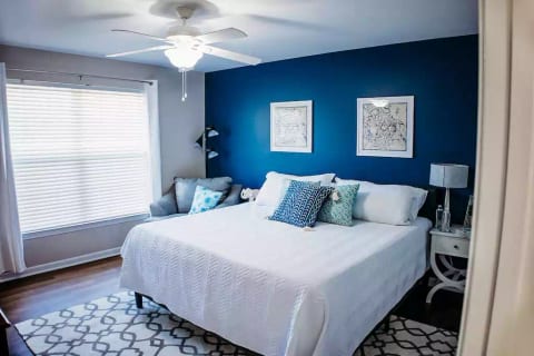 The large master suite includes a King bed, oversized leather lounge chair, and SmartTV, and a luxurious tile shower in the en suite bathroom!