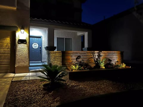 Front door & front porch area at night.