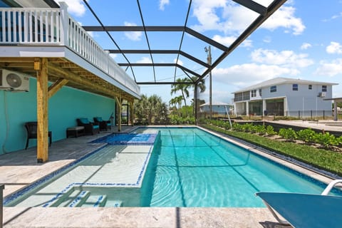 Go to the beach from expansive heated pool home