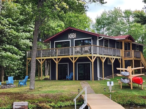 Exterior views of Loon Landing from the dock.  There are 2 kayaks and a canoe ready for you and your guests to enjoy, and a fire pit to warm up by after a day of play on the lake!