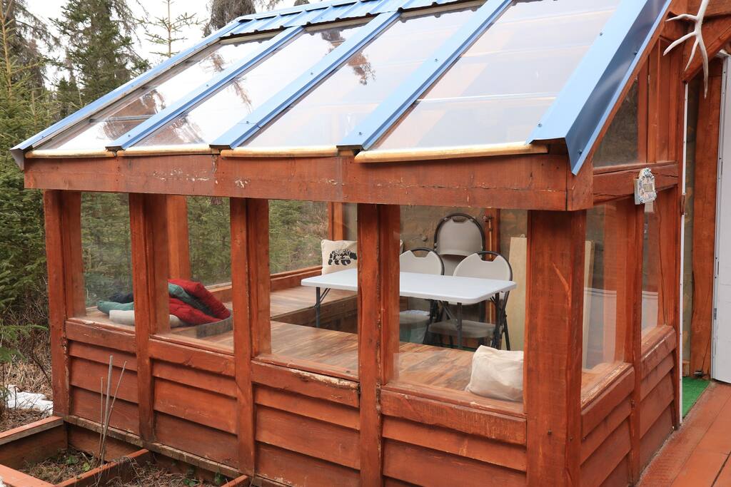 New for 2023!  We have converted our green house to a wonderful enclosed area to play a game, do a puzzle, or share a meal!  This is a shared area to both homes on the property.