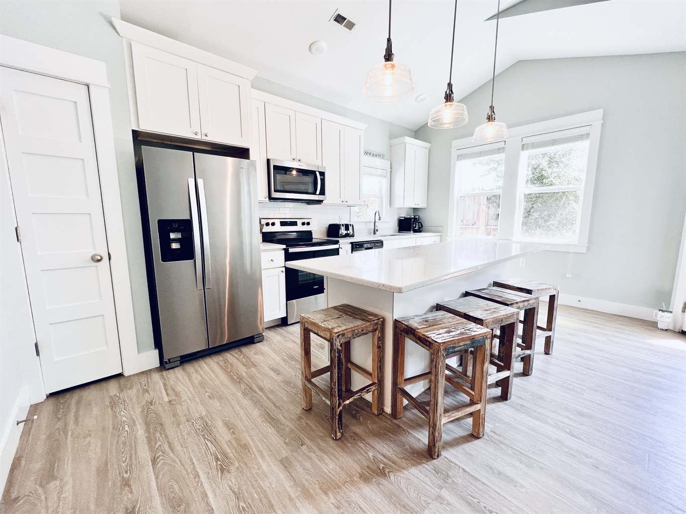 Elegance meets efficiency in this immaculate, well-appointed white kitchen.